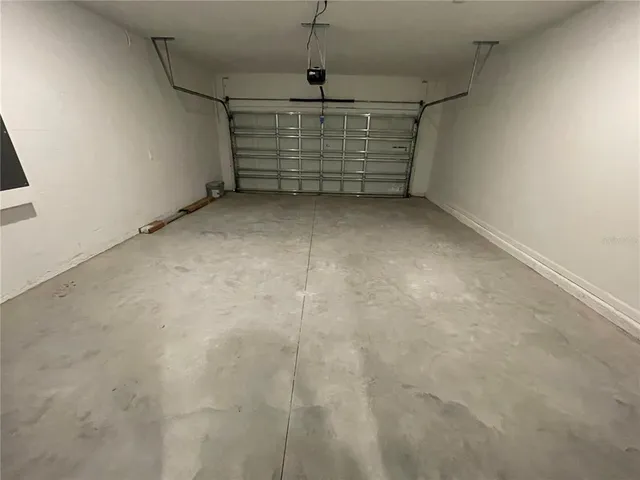 a view of swimming pool with lake view and large trees