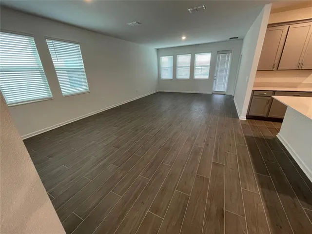 a view of kitchen with stainless steel appliances kitchen island sink and refrigerator