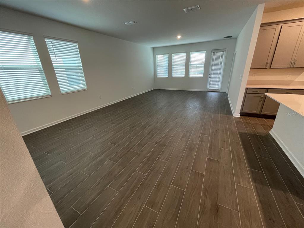 2623 Runners Circle Clermont, FL 34714 - Photo 7 of 21 an empty room with wooden floor and windows