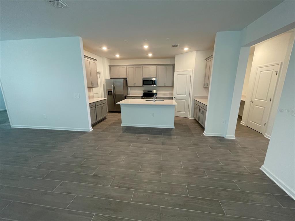 2623 Runners Circle Clermont, FL 34714 - Photo 8 of 21 a view of kitchen with stainless steel appliances kitchen island sink and refrigerator