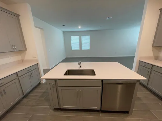a kitchen with a refrigerator a sink and a stove top oven