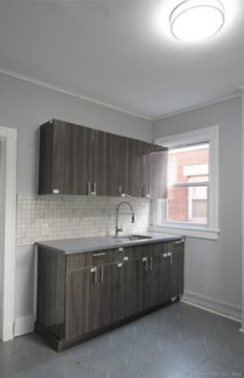 299 Dover Street, Unit 1 Bridgeport, CT 06610 - Photo 1 of 4 a kitchen with granite countertop a sink and cabinets