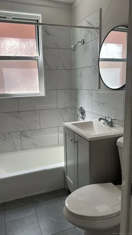 a bathroom with a sink a toilet and bathtub