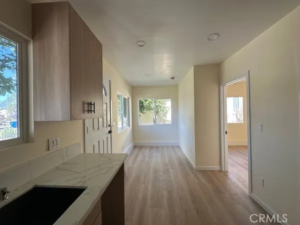 a kitchen with granite countertop a sink stove and cabinets