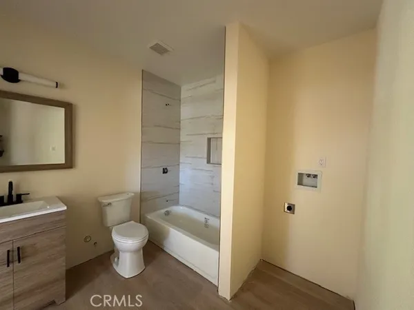 a white toilet sitting next to a bathroom sink