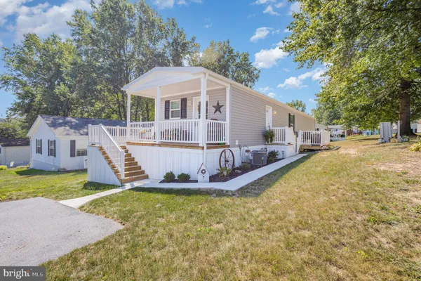 a front view of a house with a yard table and chairs