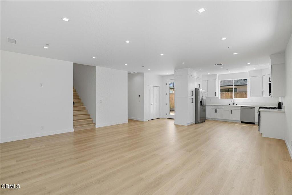 1907 Ocean Avenue Ventura, CA 93001 - Photo 15 of 51 a view of an empty room with wooden floor and a kitchen