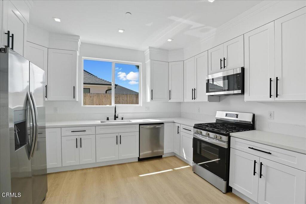 1907 Ocean Avenue Ventura, CA 93001 - Photo 17 of 51 a kitchen with stainless steel appliances granite countertop a sink stove and refrigerator