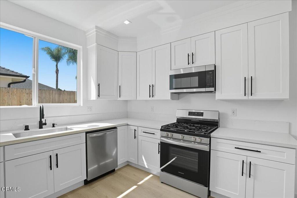1907 Ocean Avenue Ventura, CA 93001 - Photo 18 of 51 a kitchen with cabinets appliances a sink and a window
