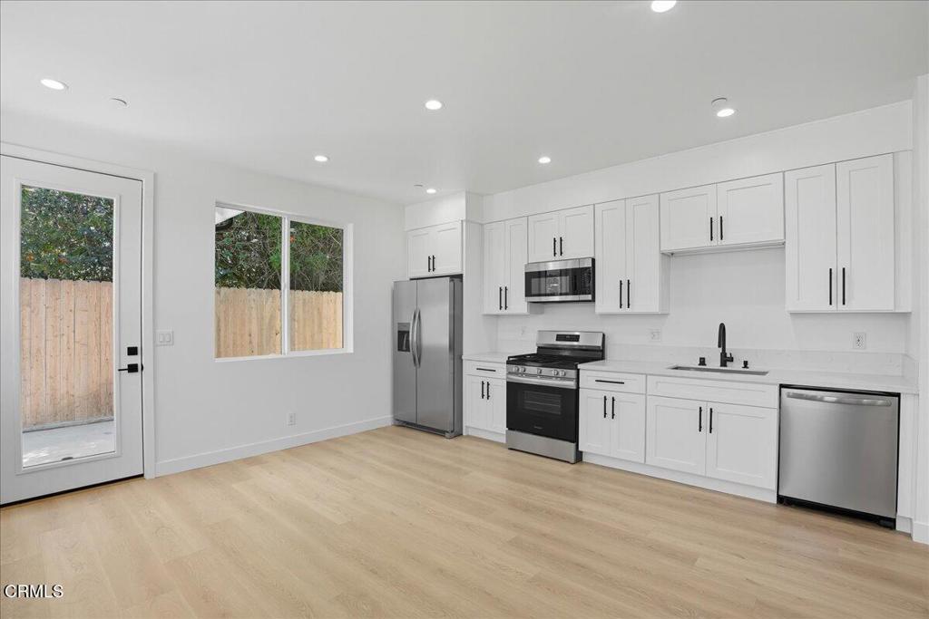 1907 Ocean Avenue Ventura, CA 93001 - Photo 34 of 51 a kitchen with stainless steel appliances granite countertop a stove a sink and a refrigerator with white cabinets
