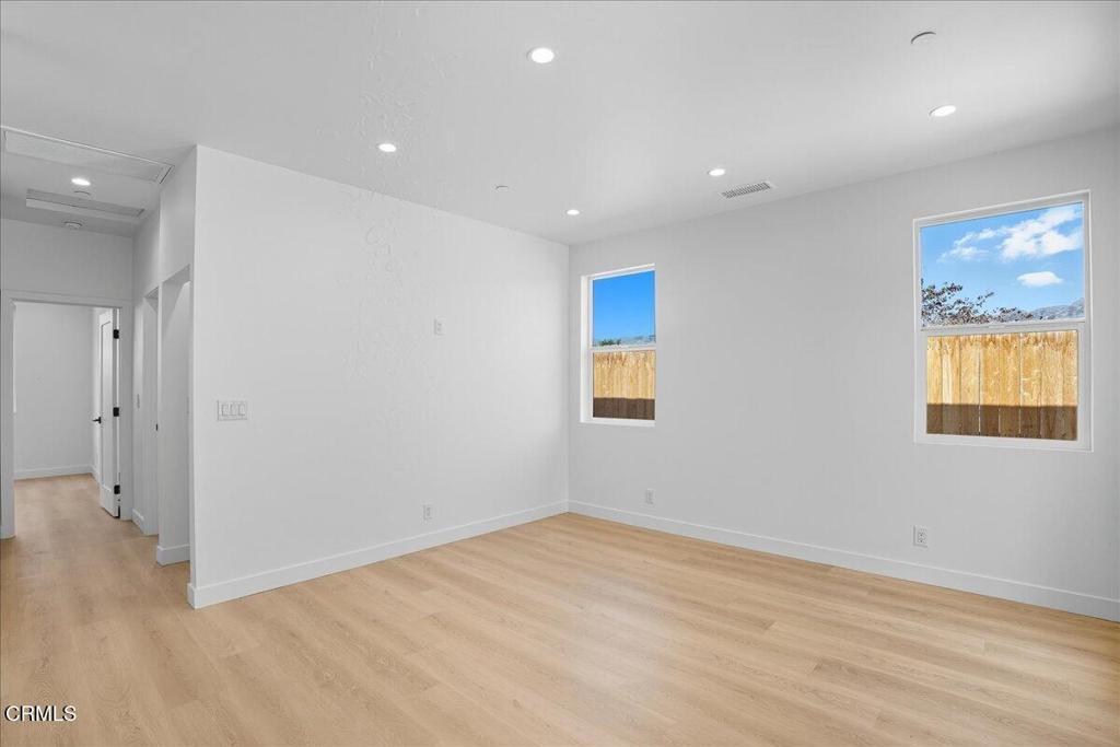 1907 Ocean Avenue Ventura, CA 93001 - Photo 36 of 51 an empty room with wooden floor and windows