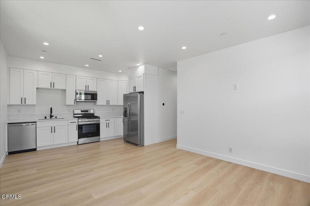 1907 Ocean Avenue Ventura, CA 93001 - Photo 40 of 51 a kitchen with stainless steel appliances refrigerator sink and stove