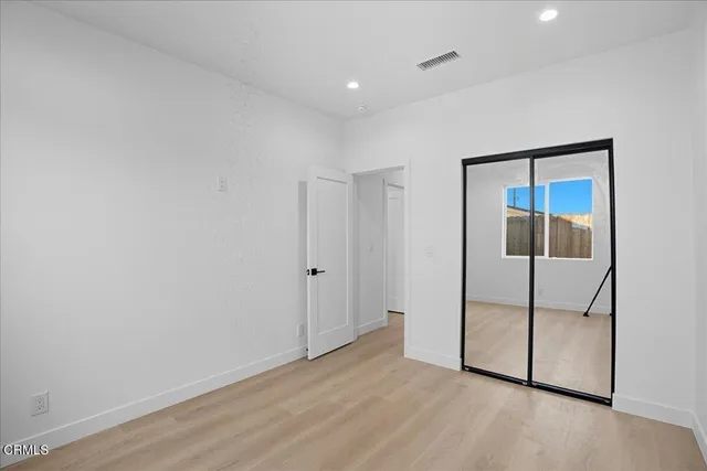 a view of a storage area cabinets and a utility room