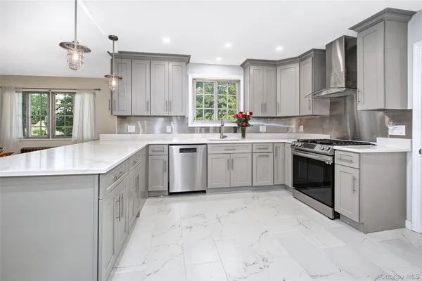 a kitchen with cabinets appliances and a window