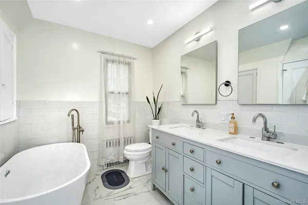 a bathroom with a double vanity sink mirror and