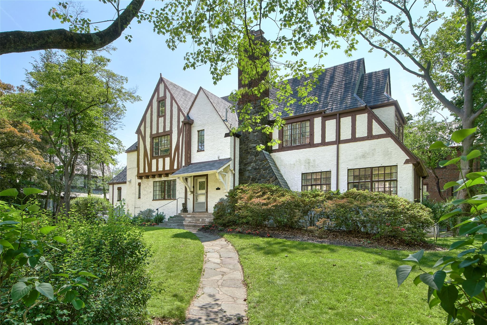 2 Byworth Road New Rochelle, NY 10804 - Photo 2 of 31 Tudor house featuring stucco siding, a front yard, and a chimney