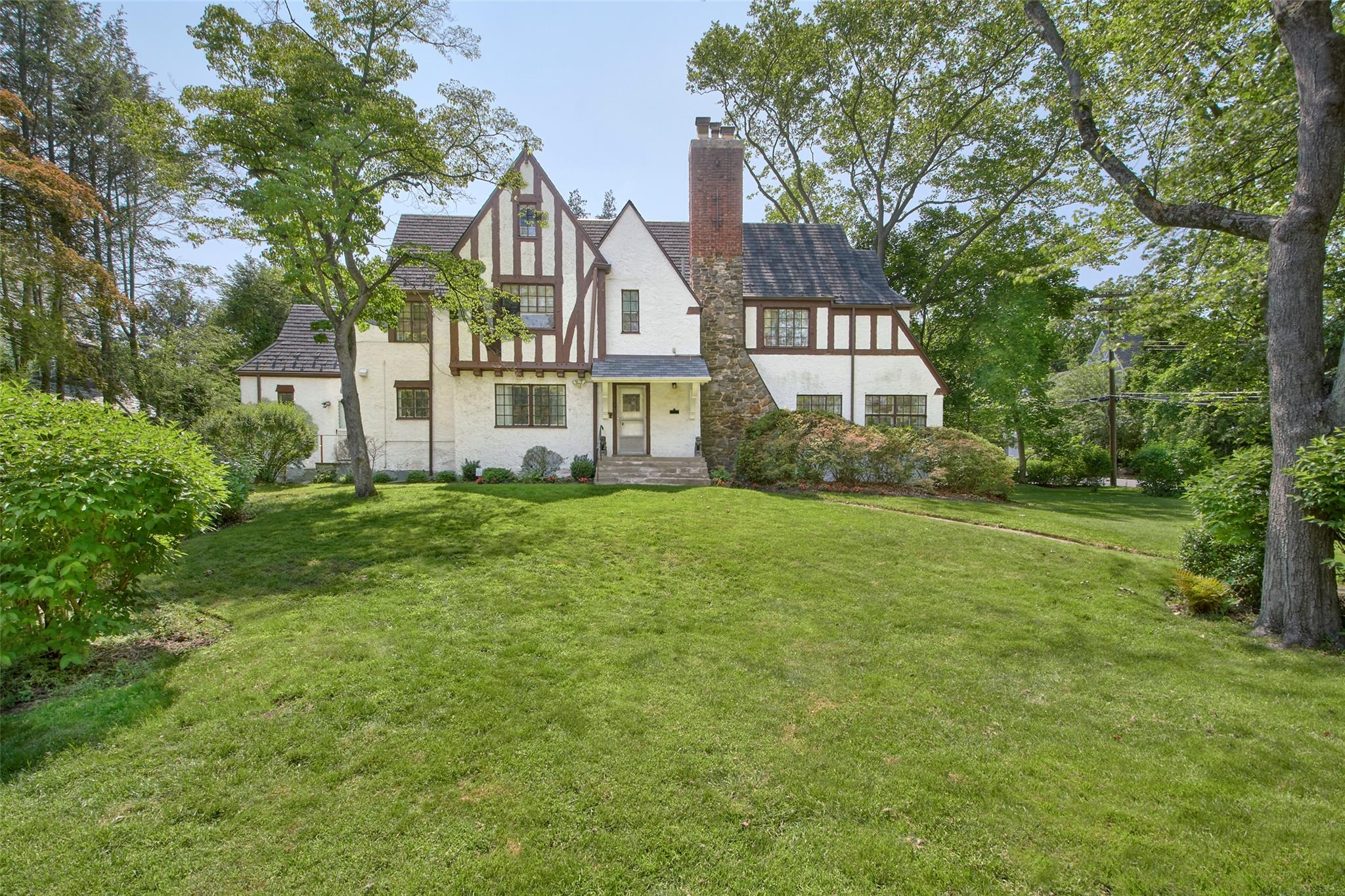 2 Byworth Road New Rochelle, NY 10804 - Photo 4 of 31 Rear view of house with stucco siding, a chimney, and a yard