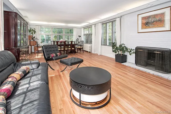 a living room with furniture a window and a fireplace