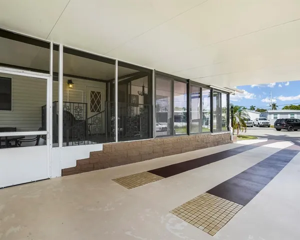 a view of a house with floor to ceiling windows