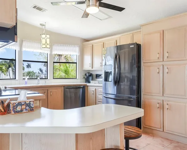 a kitchen with cabinets a sink and appliances