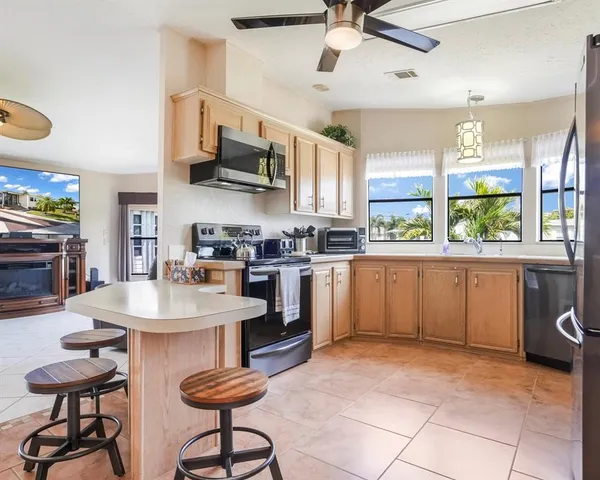 a kitchen with appliances cabinets and a sink