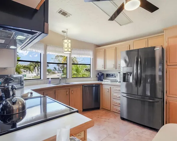 a kitchen with stainless steel appliances granite countertop a sink and a window