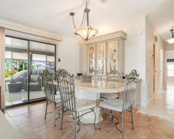a living room with furniture a fireplace and a chandelier