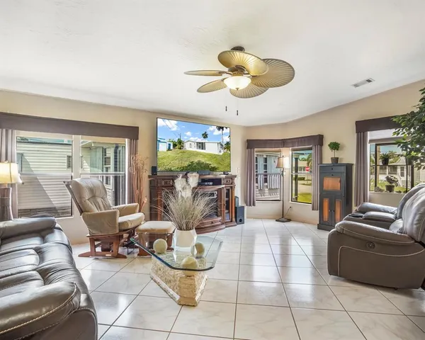 a living room with furniture a dining table and chairs