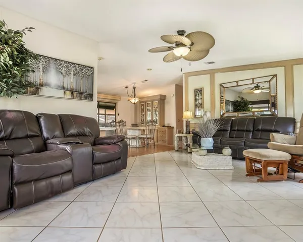 a spacious bedroom with a bed and ceiling fan