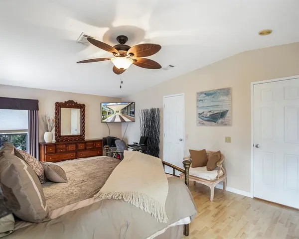 a bed room with a bed and a chair