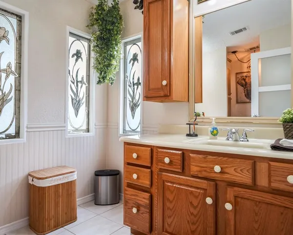 a bathroom with a sink a toilet and mirror