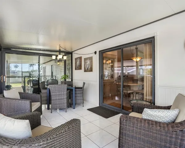 a view of a chairs and table in the balcony