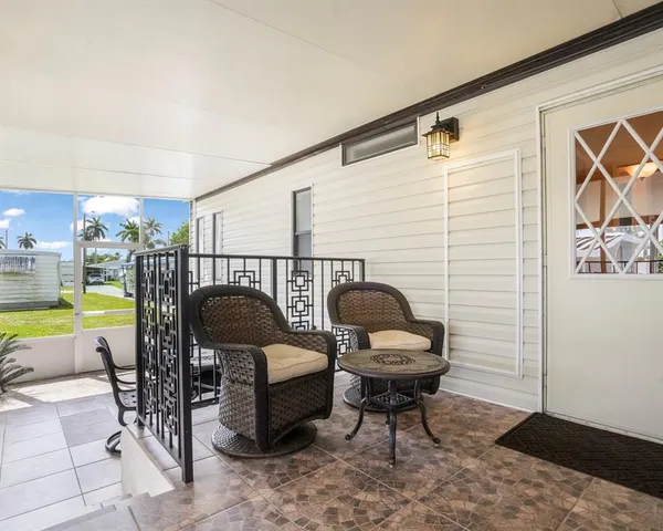 a view of a patio with dining table and chairs