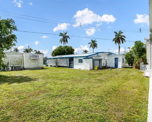 a view of a house with backyard and entertaining space
