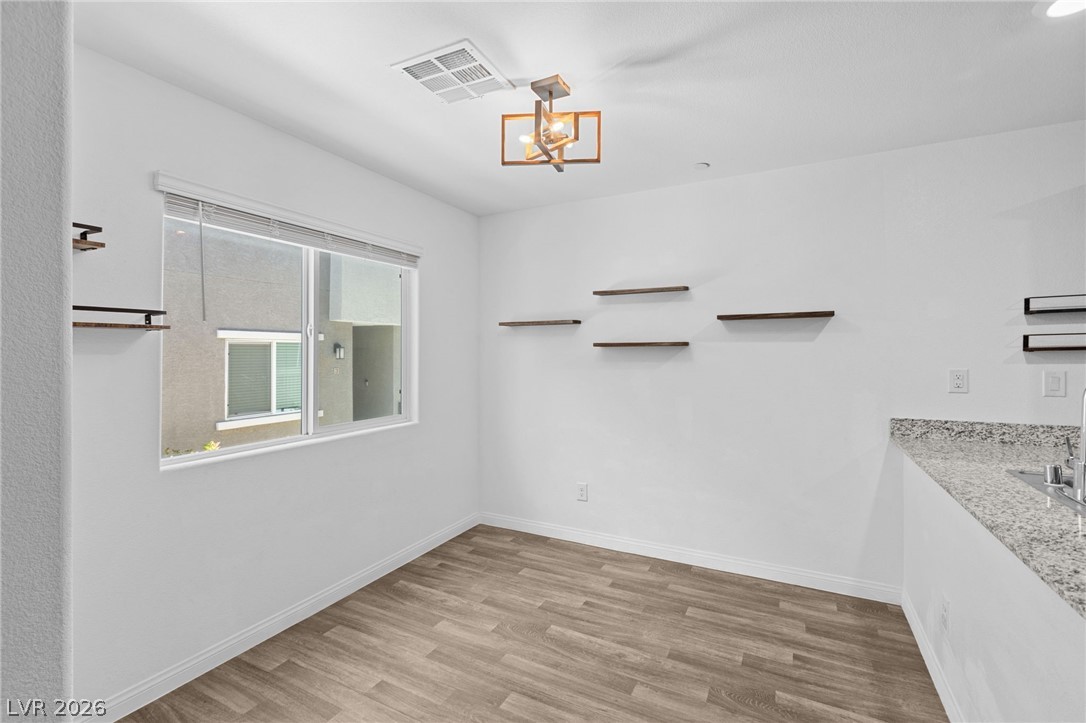 12367 Indigo Montage Road, Unit 3 Las Vegas, NV 89183 - Photo 9 of 33 This bright space features sleek flooring and a contemporary window, ideal for a dining area.