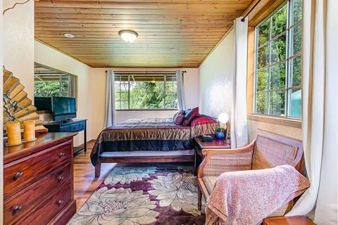 a bedroom with furniture and a window