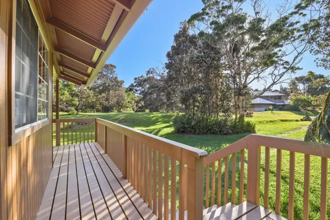 a view of balcony with wooden floor and fence
