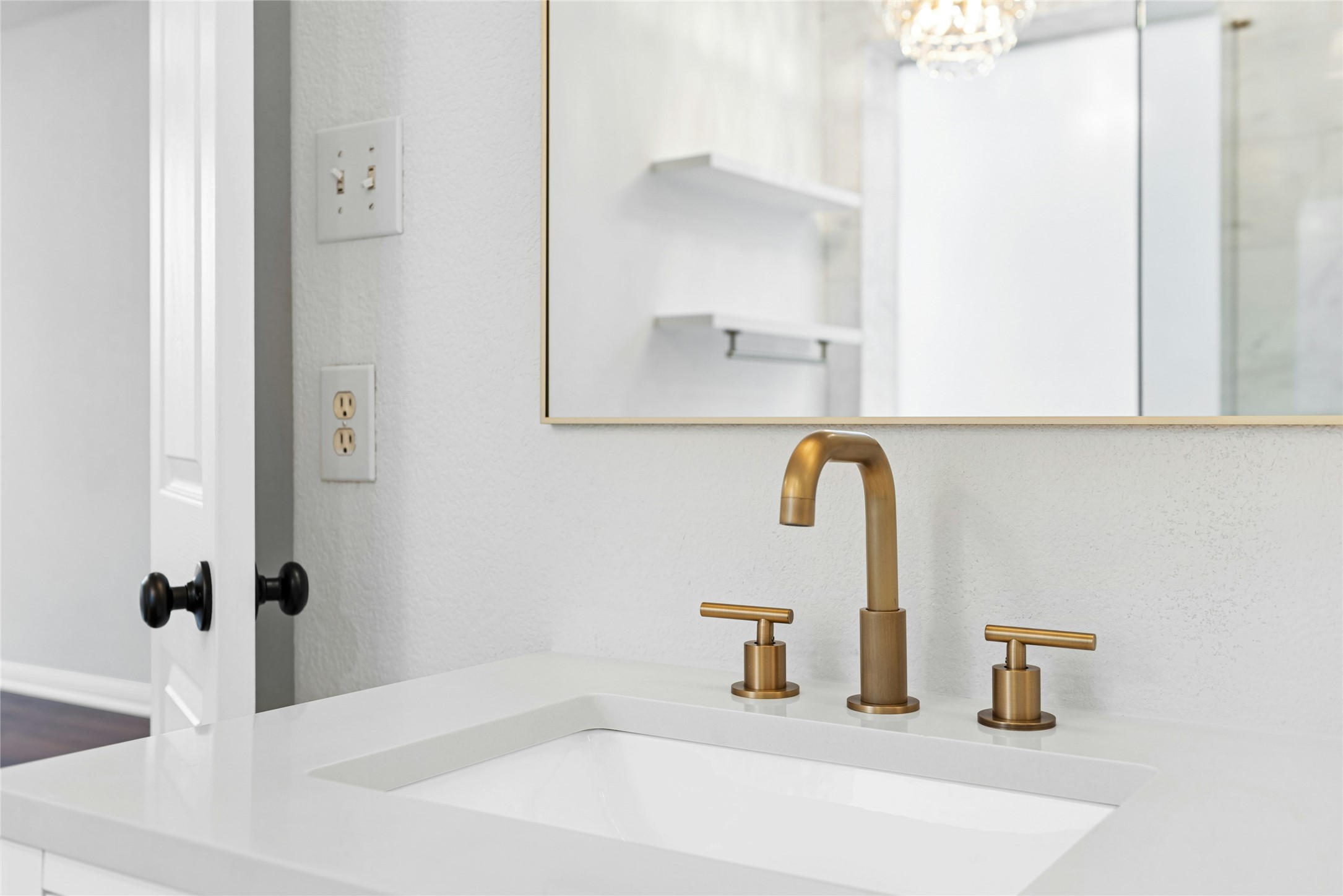 813 Caribou Ridge Trail Pflugerville, TX 78660 - Photo 30 of 39 Elegant quartz vanity accented by designer brushed-gold fixtures and a modern arched mirror, adding refined detail to the spa-inspired primary bath.