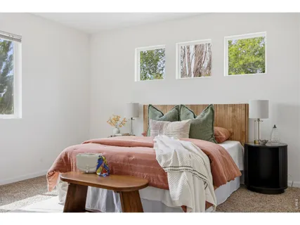a bedroom with a bed and wall painting