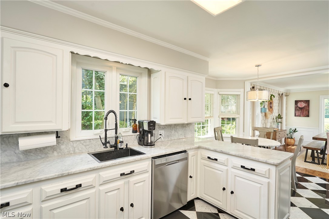 183 Overwood Road Akron, OH 44313 - Photo 11 of 34 Kitchen featuring white cabinetry, light-toned stone countertops, and a black and white checkered floor