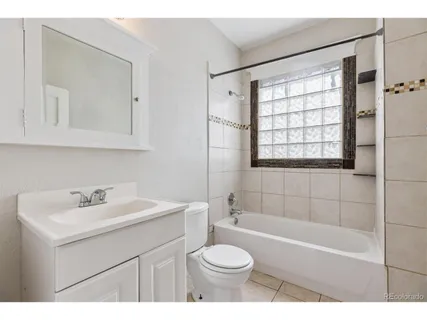 a bathroom with a sink toilet a mirror and shower