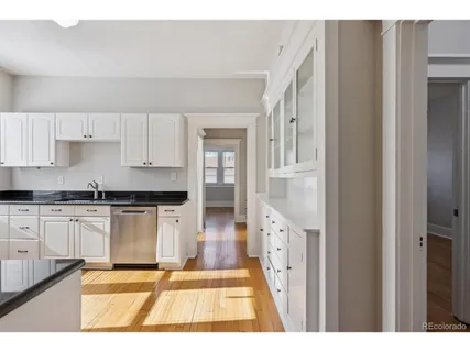 a kitchen with stainless steel appliances granite countertop a refrigerator and a stove