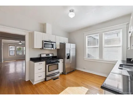 a kitchen with stainless steel appliances granite countertop a stove a sink and a refrigerator