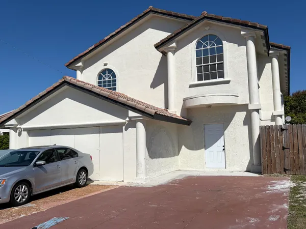 a view of a car parked in front of a house