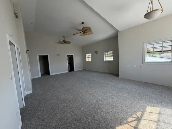 a view of a big room with windows and cabinet