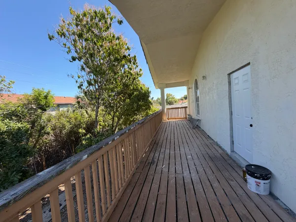 a view of balcony with wooden floor