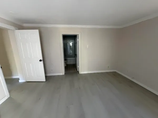 an empty room with wooden floor and closet