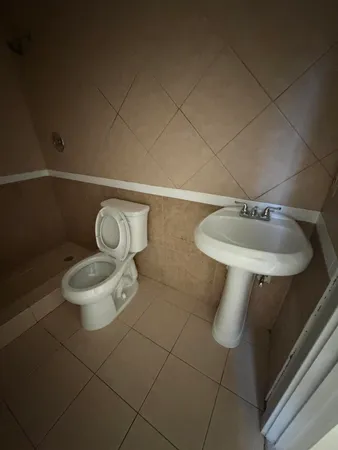 a bathroom with a toilet and a sink