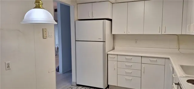 a kitchen with a sink a stove and refrigerator