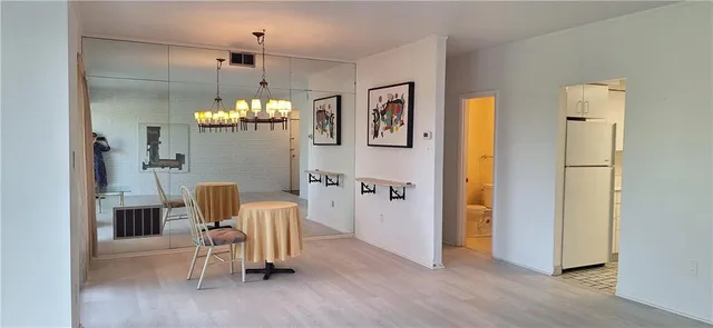a view of a dining room with furniture and chandelier